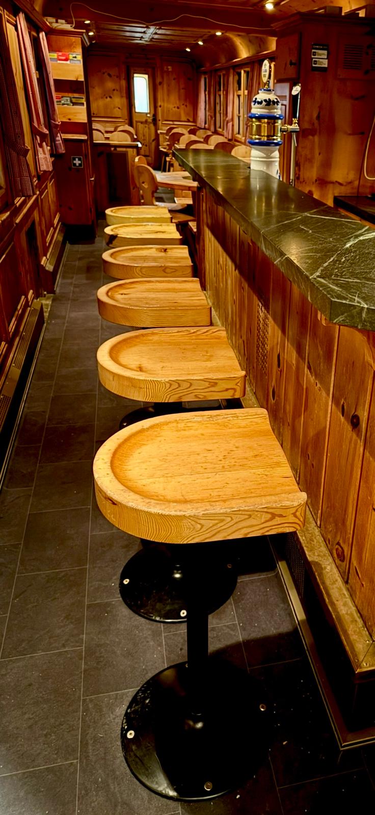 Alpine Pub wagon with a stone-topped bar, beer tap and sculptural wooden stools